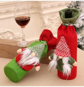 Detail of red and green Gnome wine bottle covers for festive Christmas table decorations