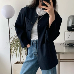 Navy blue blazer with white turtleneck and jeans in a modern minimalist mirror selfie