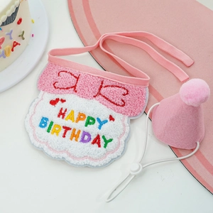 Detailed view of pink plush dog birthday bib and party hat with soft fiber textures