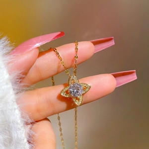Titanium steel necklace with clover pendant and zircon crystals held in hand