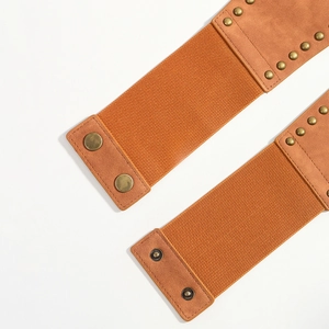 Detail view of orange-brown elastic corset belts with metallic studs and snap buttons