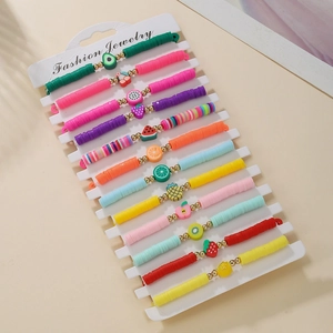 Colorful fruit heishi bead bracelet set with gold metal accents on display card