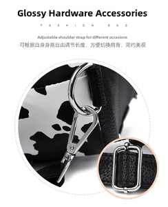 Detail of glossy silver hardware and adjustable leather strap on a cow print tote bag