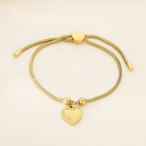 Detail view of adjustable gold snake chain bracelet with heart pendant and sliding clasp