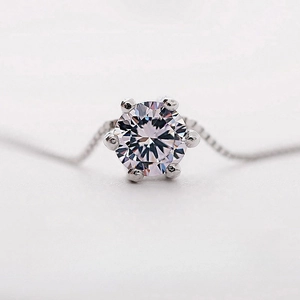 Classic six-prong round zircon solitaire necklace with silver chain on white background