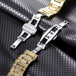 Detail of gold metal watch straps and stainless steel fold-over clasps with crystals