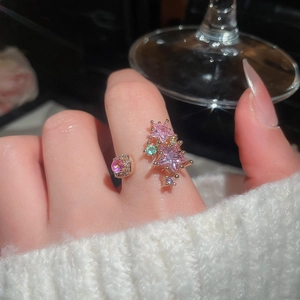 Detail of pink star zircon open ring with micro-set diamonds on gold plated band