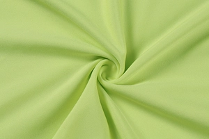 Detail shot of the light green fabric texture with elegant pleated swirl pattern