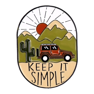 Detailed enamel pin with mountains, red off-road car and Keep It Simple lettering