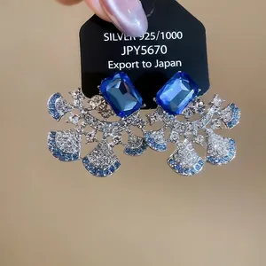 925 silver fan-shaped earrings featuring blue square crystals and pavé rhinestones