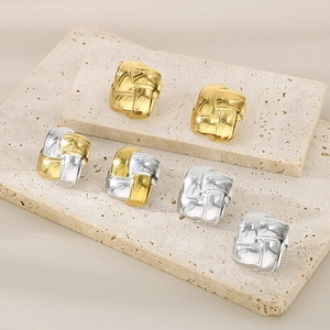 Detail of square woven texture stud earrings in gold, silver, and mixed finishes