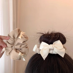 Brown waffle fabric scrunchie with satin bows for high ponytail styling and hair decor