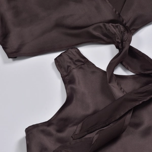 Detail of silk satin fabric showing tie-back design and chocolate brown texture