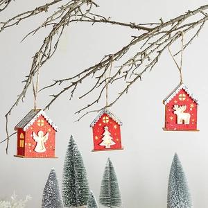 Red Christmas LED wooden houses with snow tops and deer hanging on rustic branches