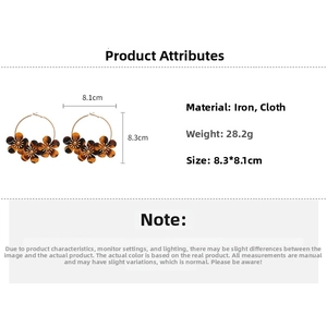 Detail view of leopard print fabric flower hoop earrings with size and weight specs