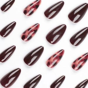 Almond-shaped press-on nails with deep burgundy red and leopard tortoise pattern