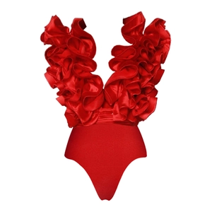 Close-up of bright red deep V-neck swimsuit with layered ruffle details and satin fabric