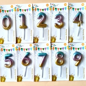 Macro shot of 0-9 galaxy gradient birthday candles in individual blister card packaging