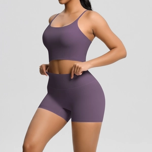 Detail of cross-back sports bra and high-waist yoga shorts set in textured mauve color
