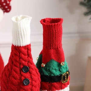 Knitted Christmas wine bottle covers with red cable knit and green holiday bell designs