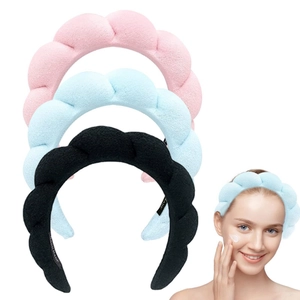 Detail showing pink, blue, and black braided spa headbands in soft terry cloth material
