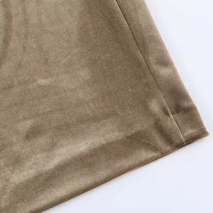Macro view of olive velvet fabric texture and clean hem stitching on the dress