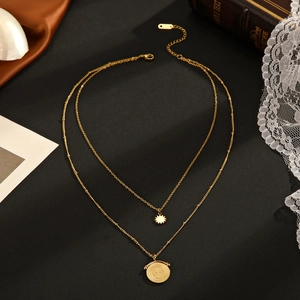 Elegant 14K gold double-layer necklace with sunburst star and vintage coin pendants