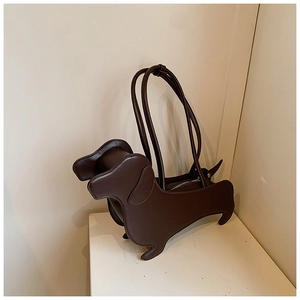 Detailed close-up of stitching and leather texture on brown dachshund shoulder bag