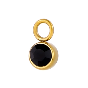 Detail of round black faceted gemstone pendant with polished golden metal bale