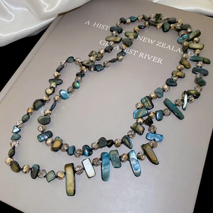 Detail of irregular shell beads and iridescent crystals on a double-layer vintage necklace