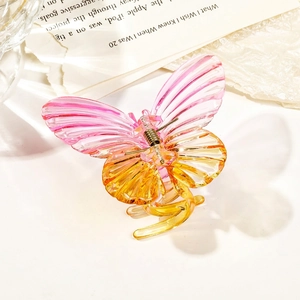 Macro detail of butterfly hair claw clip with pink gradient transparent resin texture