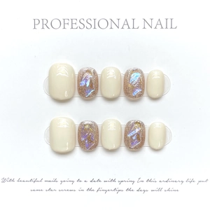 Detail of 10pcs set brown and cream press-on nails with sparkling glitter and gold flakes