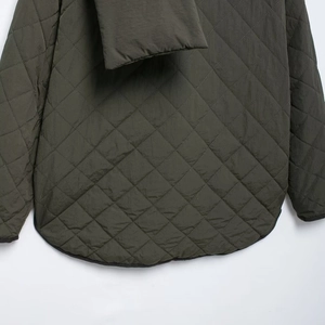 Deep green quilted jacket for women with stylish back hem detail in casual autumn style