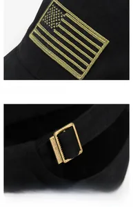 Detail of USA flag gold embroidery and adjustable metal buckle on black cotton baseball cap
