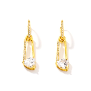 Golden safety pin earrings with heart-shaped zircon and pave crystals on white background