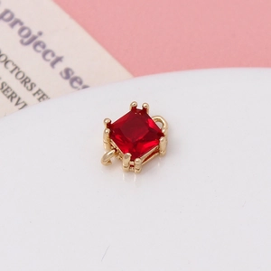 Macro shot of red square crystal pendant with gold claw setting for jewelry making