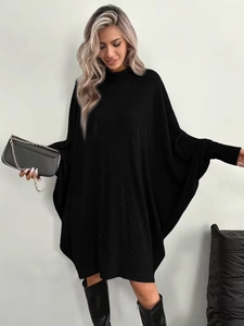 Close-up of black turtleneck knit dress with batwing sleeves and ribbed texture material