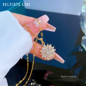 Close-up of a titanium steel gold sunflower necklace with crystals on a female model