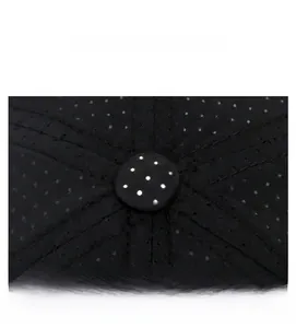 Detailed macro view of black mesh baseball cap crown with breathable vent holes