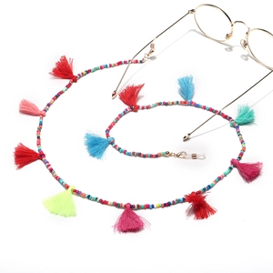 Handmade colorful seed bead eyewear chain with vibrant cotton tassels on white background