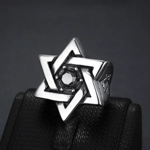 Macro view of men's stainless steel hexagram ring featuring a black center gemstone