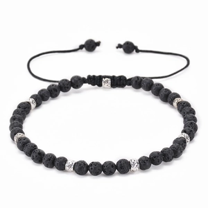 Detail of adjustable lava stone beaded bracelet with ornate silver-toned spacers
