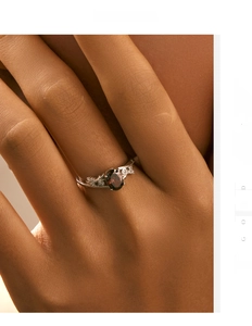 Detail of vintage 925 silver ring with oval garnet gemstone and intricate vine engravings