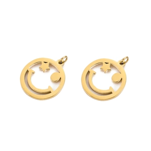 Close-up of two golden hollow smiley face pendants with star and dot eye details