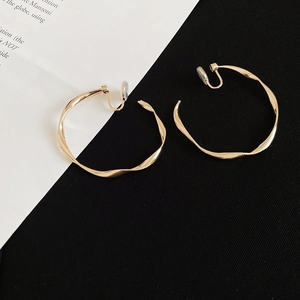 Macro shot of gold twisted hoop clip-on earring with soft pads for non-pierced ears