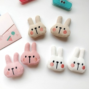 Cute knitted bunny doll heads in pink, white, and beige for DIY craft accessories