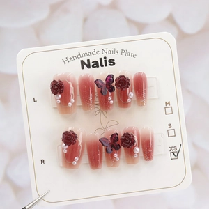 Macro detail of handmade press-on nails featuring gradient colors, 3D roses and butterflies