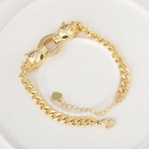 Golden cheetah head bracelet with green gemstone eyes and micro-set cubic zirconia stones
