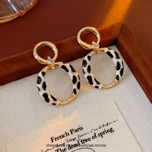 Vintage gold leopard print hoop earrings with crystals on a brown jewelry box