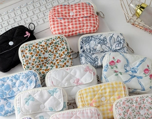 Detailed view of quilted mini storage pouches in various floral and plaid patterns